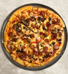 a pizza sitting on top of a pan covered in toppings