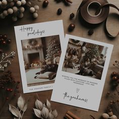 two christmas cards on a table with decorations