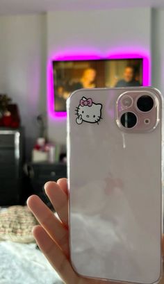 someone is holding up their phone case with a hello kitty sticker on it