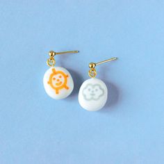 Introducing the perfect pair of mismatched besties for your ears! These adorable polymer clay earrings feature a cheerful sun and its constant companion, a fluffy cloud. Just like true friends, this sun and cloud duo stick together through every forecast. These earrings radiate positivity and playfulness sure to put a smile on your face and those around you. Ideal for spring and summer events, casual outings, coffee dates or special occasions like Valentine's Day and Mother's Day, they appeal to women and girls of all ages who appreciate fun, feminine accessories. Lightweight and versatile, these earrings make thoughtful novelty gifts for friends, sisters, teachers, or nature lovers, and can effortlessly transition from everyday wear to more festive occasions. Their fun playful yet elegant Fun White Earrings For Everyday, Fun White Everyday Earrings, Cute White Hand Painted Jewelry, Cute Hand Painted White Jewelry, White Fun Dangle Earrings, Novelty White Drop Earrings, White Kawaii Drop Earrings, White Novelty Drop Earrings, Playful White Jewelry With Ear Wire