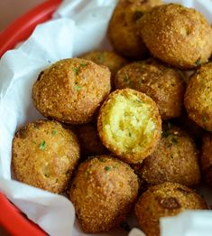 a red bowl filled with fried food on top of a table