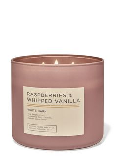 a pink candle that is sitting on a white surface with the words raspberries and whipped vanilla