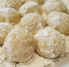 powdered sugar covered donuts in a white bowl