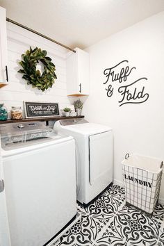 a white washer and dryer sitting in a laundry room next to a sink