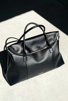 The Hugo Duffle by Nakedvice is a unisex duffle bag crafted from smooth black leather and gold hardware. Featuring two top handles, The Hugo Duffle opens up to a spacious interior with plenty of room to store your travel essentials. We designed The Hugo Duffle so that it can be used as an overnight bag, gym bag, baby bag, or travel bag.
 Colour: BLACK/GOLD Luxury Baguette Pouch Bag For Daily Use, Timeless Black Luxury Evening Bag, Luxury Ralph Lauren Shopping Bag, Luxury Formal Nylon Bags, Gym Bag Outfit, Overnight Bag Essentials, Luxury Duffle Bag, Luxury Travel Bags, Designer Travel Bags