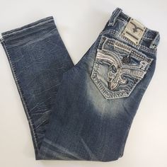 Rock Revival Kidd J204 Straight Stretch Premium Blue Jeans Mens Size 30x32 Elevate your denim game with these Rock Revival Kidd J204 Straight Stretch Premium Blue Jeans. The 5-pocket design, low rise, and ruffle, beaded, and embroidered accents make these jeans a statement piece. The cotton and cotton blend fabric with a medium wash and faded pattern add to the versatile style that can be worn in any season. These jeans are perfect for the hipster, money, TV, and city-inspired look, as well as the retro and hip hop themes. The zip closure and comfortable stretch fit ensure a secure and flattering fit. Machine washable for easy care, these Rock Revival jeans are a must-have for any stylish man's wardrobe. Rock Revival Jeans Mens, Blue Jeans Mens, Rock Revival Jeans, Rock Revival, Men's Wardrobe, Size Clothing, Stylish Men, Mens Jeans, Blue Jeans