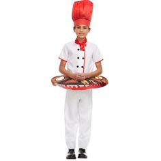 a young boy wearing a chef's outfit and holding a tray with food on it