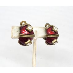 This is part of Chairish’s Costume Jewelry assortment.  1980s goldtone red enamel with round clear rhinestones half hoop clip earrings. Marked "YOSCA©." Measure: 1 inch long by 3/4 inches wide. Condition: Very good; some darkening to metal on backs. The matching cuff bracelet is also available for purchase. Enamel Clip-on Earrings For Evening, Red Enamel Clip-on Jewelry, Red Enamel Clip-on Earrings, Vintage Jeweled Metal Clip-on Earrings, Vintage Red Clip-on Earrings For Evening, Vintage Enamel Clip-on Earrings For Evening, Clip Earrings, Clear Rhinestones, Costume Jewelry