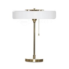 a brass table lamp with a white shade