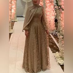 A Neutral-Toned, Long-Sleeved Dress With Delicate Gold Sequins, Worn Once And Made In Turkey. Features Balloon Sheer Sleeves And A High Collar For Added Elegance And Coverage, This Dress Exudes Sophistication With Its Simple Yet Refined Design For Hijabis. Can Fit For Sizes 4-6, Long Sleeve Mother Of The Bride Dress For Banquet, Long Sleeve Maxi Dress For Eid Banquet, Festive Long Sleeve Dresses With Sheer Sleeves, Eid Sequined Long Sleeve Gown, Eid Sequin Long Sleeve Gown, Formal Evening Dress For Eid, Long Sleeve Dresses For Eid Banquet, Long Sleeve Dress For Banquet And Eid, Long Sleeve Gown For Eid Banquet