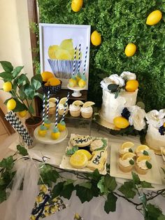 a table with lemons and cupcakes on it