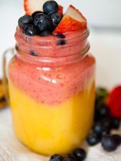 a jar filled with fruit sitting on top of a table