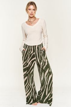 Unleash your inner wild in the Zebra Print Knit Pants! These beauties are crafted from a cozy knit fabric that's as comfy as your PJs but chic enough for the streets. The zebra print roars with bold personality, while the elasticized mid-rise waist ensures a comfortable, flattering fit that moves with you. The wide leg silhouette adds a touch of effortless elegance, making these pants perfect for dressing up or down. Casual Wide Leg Bottoms With Zebra Print, Spring Wide Leg Zebra Print Bottoms, Spring Wide Leg Zebra Print Pants, Casual Zebra Print Bottoms For Spring, Casual Stretch Zebra Print Bottoms, Bold Personality, Womens Trousers, Womens Pants, Cozy Knit