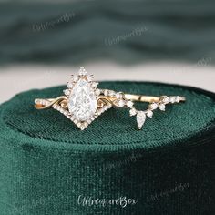 a diamond ring sitting on top of a green box