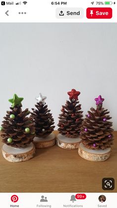 three pine cones are sitting on top of each other, with christmas decorations around them