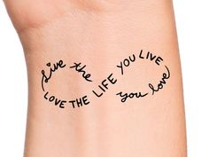 a woman's arm with writing on it that says live the life you love