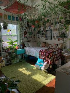 a bedroom with lots of plants and pictures on the walls