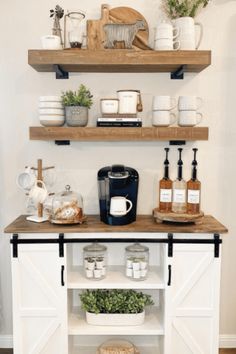 the shelves are filled with coffee, spices and other kitchen items on top of them