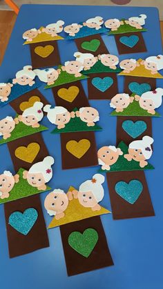 paper cut out sheeps and hearts on a blue table