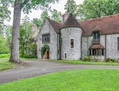 an old brick house in the middle of a park