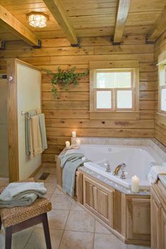 a bathroom with a large jacuzzi tub next to a wooden wall and ceiling