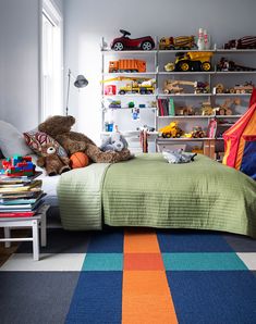 a child's bedroom with toy cars and toys on the shelves above the bed