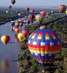 many colorful hot air balloons floating in the sky