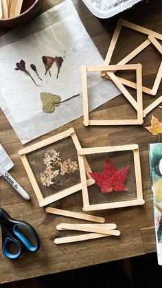 some pictures and scissors on a wooden table