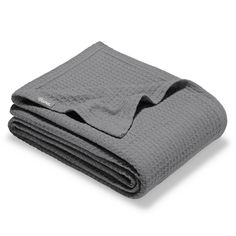 the grey blanket is folded on top of each other