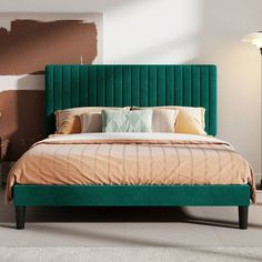 a bed with green headboard and pillows in a room that has been painted brown