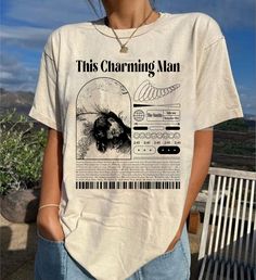 a woman wearing a t - shirt that says this charming man