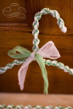 a green and white string with a bow on it