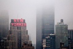 the new york city skyline is covered in fog