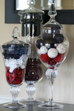 two glass vases filled with different types of candies