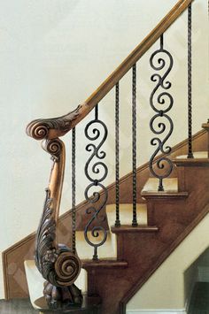 a staircase with wrought iron railings and handrail