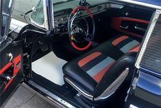 the interior of a classic car with red and black stripes