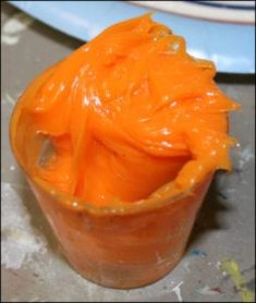 an orange substance is in a cup on the table