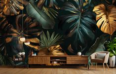 a living room with large tropical leaves on the wall and wooden flooring in front of it