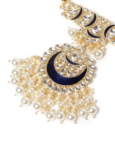 This impressive jewelry set consists of a drop necklace and a pair of chandbali earrings. The multi-stranded, beaded & enamelled necklace shown in dark-blue and off-white color comes gold-plated with kundan stone studs, and secured with an adjustable drawstring closure. A pair of matching chandbali earrings come secured with a post and back closure. This statement piece can add impact to any outfit for any festive occasion! Product color may vary based on the monitor or screen you are using.See Chandbali Jewelry With Dangling Beads For Diwali, Blue Jewelry For Eid Gift, Bollywood Chandbali Jewelry With Dangling Beads, Bollywood Style Chandbali Jewelry With Dangling Beads, Blue Chandbali Kundan Necklace, Kundan Chandbali Jewelry With Dangling Beads, Bollywood Kundan Jewelry With Dangling Beads, Beaded Chandbali Kundan Necklace, Festive Chandbali Kundan Necklace With Dangling Beads