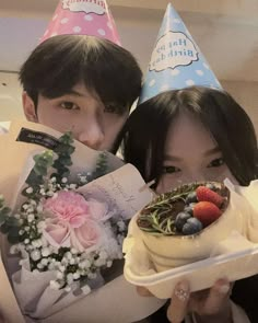 two people holding plates with flowers and fruit on them