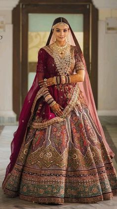 a woman in a red and gold bridal gown