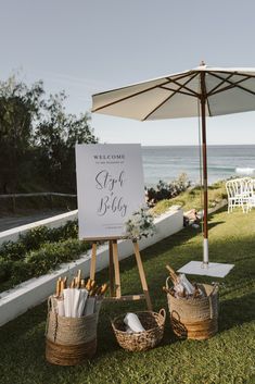 a welcome sign and baskets on the grass