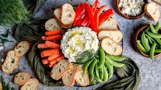 a platter filled with vegetables and dip