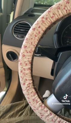 a car steering wheel cover with flowers on it