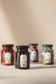 four jars are lined up on the table