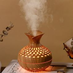 a wooden vase sitting on top of a table with steam coming out of the top