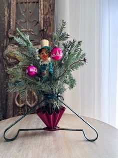 a vase filled with ornaments on top of a wooden table