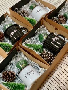 four boxes filled with different types of christmas ornaments and pine cones on top of a bed