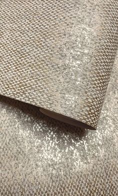 an upholstered fabric with silver and brown patterns