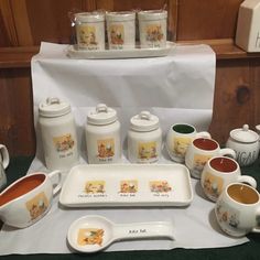 a table topped with cups and saucers filled with different types of condiments